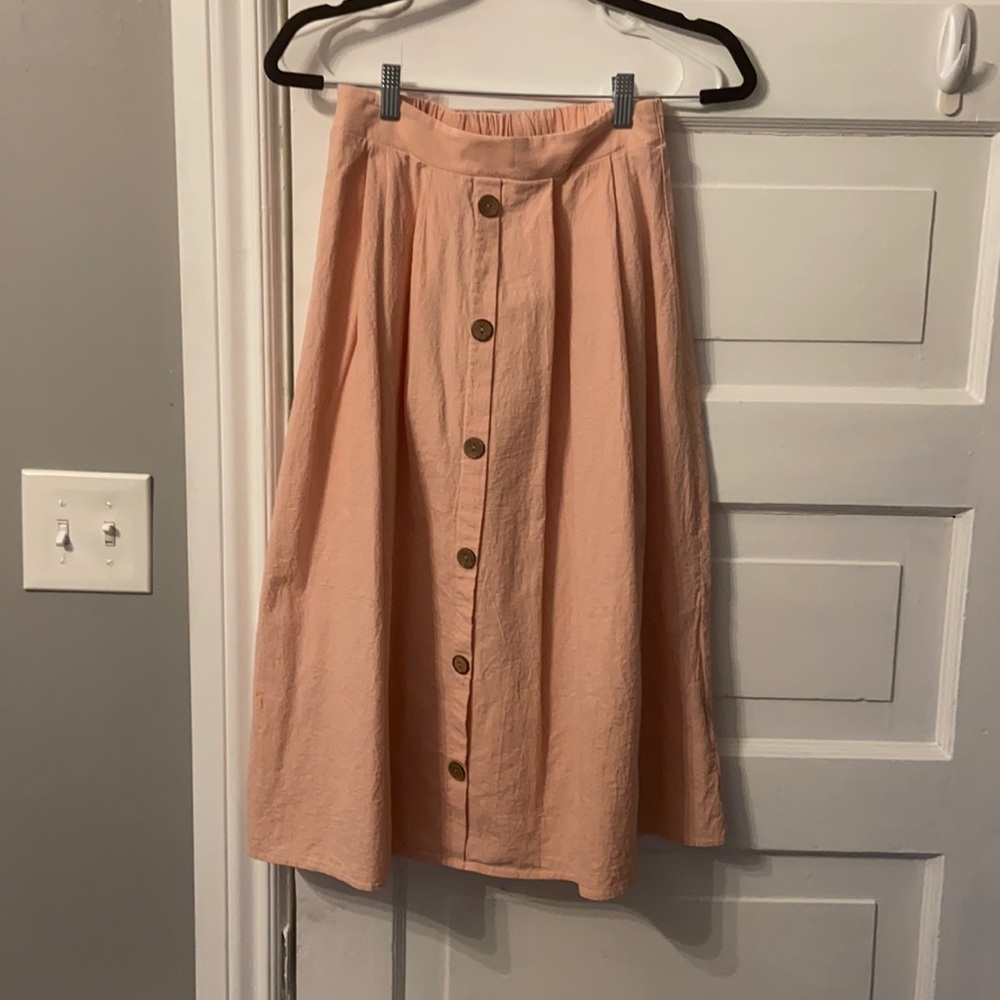 SHEIN long peach skirt with wood button details down the front.